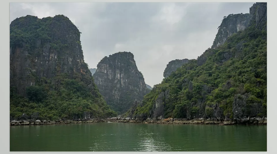 Gumroad - Halong Bay Reference Pack - The misty morning light gently touches the jagged peaks, offering a serene view of the bay's quiet waters.